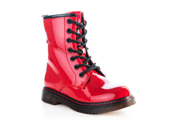 istock Red shiny leather shoes. Shining boots isolated. 1347506899