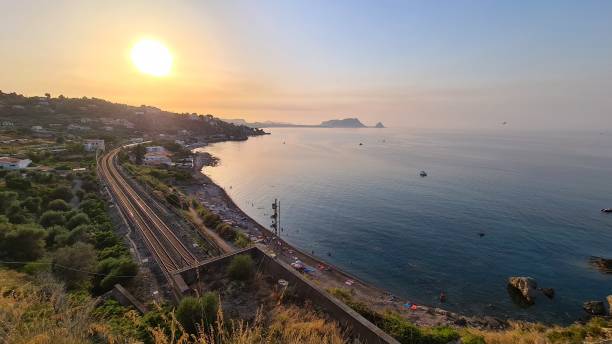 istock The setting sun in a fantastic Sicilian coast with a railway 1347507869