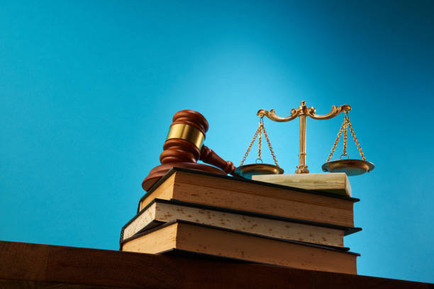 istock libra scale and gavel hammer on stack of books against blue background 1347508075