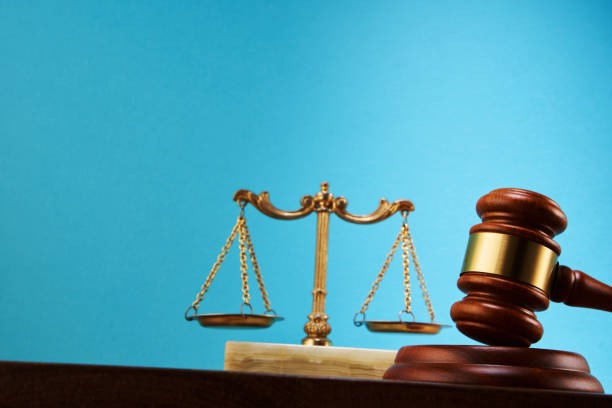 istock libra scale and gavel hammer against blue background 1347508210