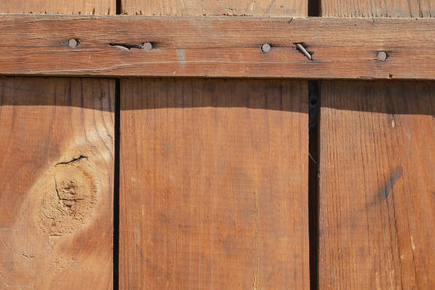 istock Three wooden boards nailed together. Brown boards perpendicularl 1347508946