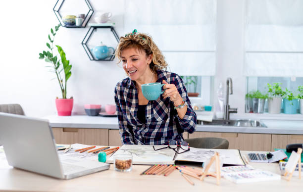 istock Attractive woman doing a drawing with a pencil in the notebook 1347510508