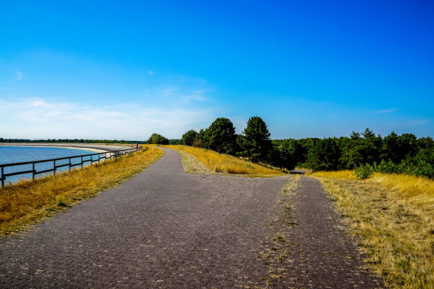 istock A path next to a water reservoir and a dry field. 1347511727