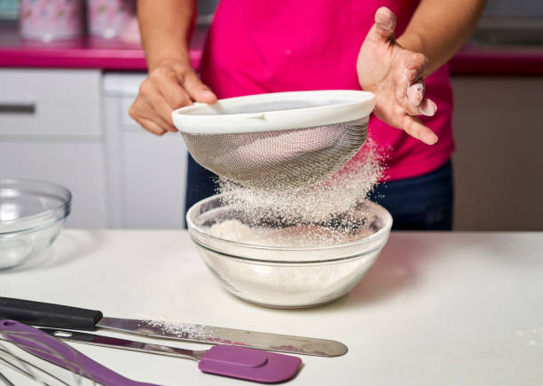 istock a woman strains flour to make a sponge cake 1347512853