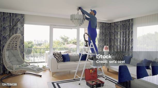 Chandelier Installing Stock Photo - Download Image Now - Electrician, Residential Building, Chandelier