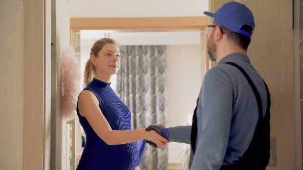 istock Repairman Handshake in Door 1347515573