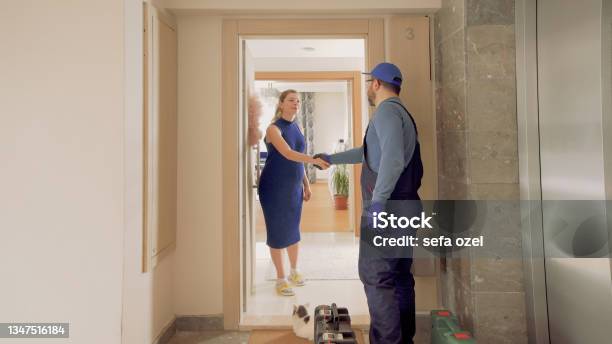 Repairman Handshake In House Door Stock Photo - Download Image Now - Air Conditioner, Service, Repairing