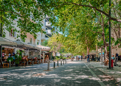 Athens, Greece - July 11 2021: The start of Dionysiou Areopagitou St near Amalias Ave. It is a pedestrian street round the south slope of the Acropolis in the Makrygianni district, with sidewalk cafes.