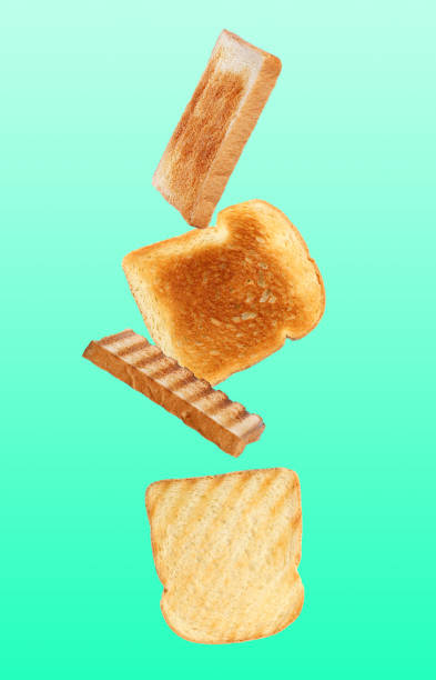istock Tasty toasts falling on color background 1347518588