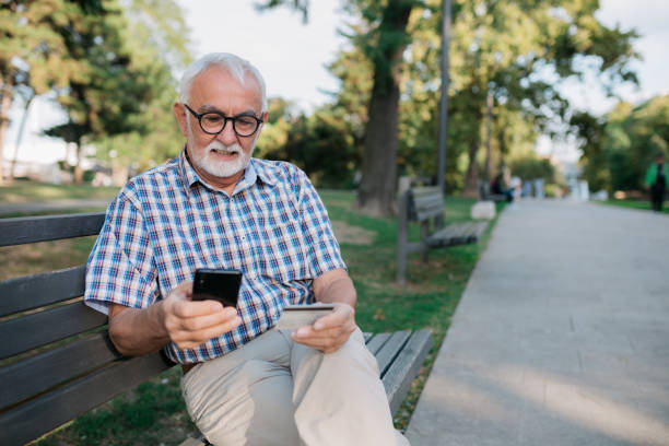 istock Senior Caucasian man using a credit card and a smart phone 1347520363