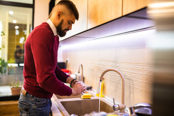 istock A young man washing the dishes 1347520710