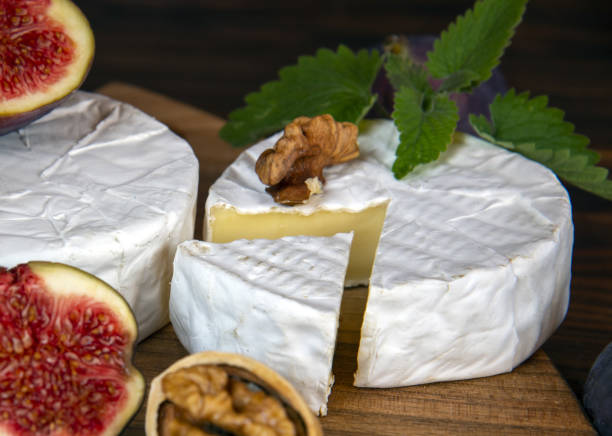 istock Cheese with white mold and figs lie on a cutting board . 1347520800