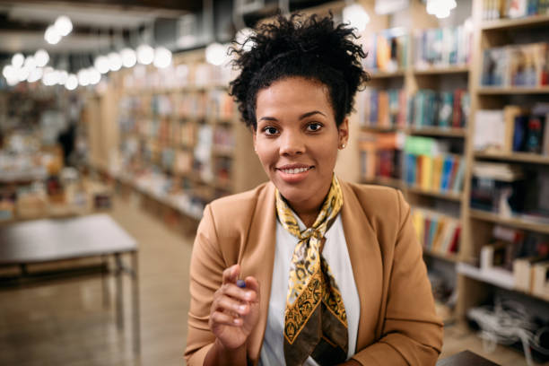 istock Happy African American female professor holding online class from a library. 1347520967