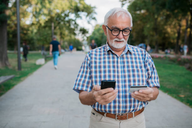 istock Senior Caucasian man using a credit card and a smart phone 1347521703