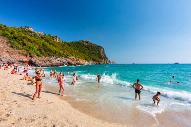 Tourists on the Cleopatra Beach of Alanya at the Mediterranean Sea, Turkey. stock photo