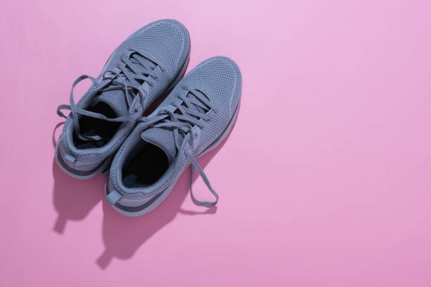 istock grey sneakers on a pink background 1347522174