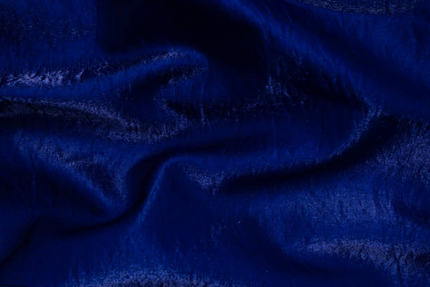 istock Purple shiny fabric as background. Top view. 1347522829