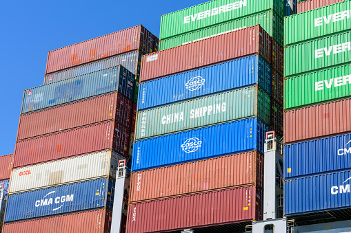 China Shipping, Evergreen, CMA CGM, Cosco Shipping Hamburg Sud containers stacked at container ship and waiting for unloading - Los Angeles, California, USA - 2021