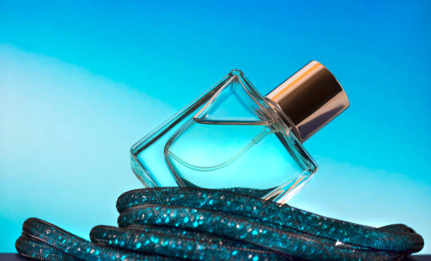 Perfume bottle on a turquoise background. Eau de Toilette.