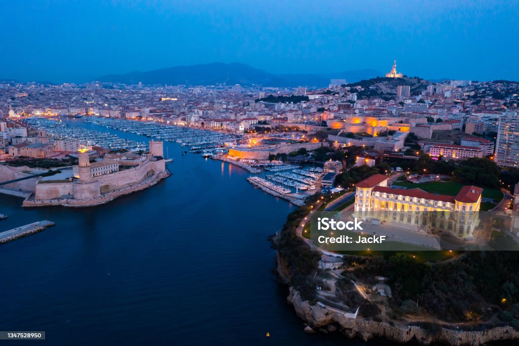 Bir's eye view of Marseille in evening Bir's eye view of Marseille in evening with turned on city lights. Palais du Pharo visible from above. Marseille Stock Photo