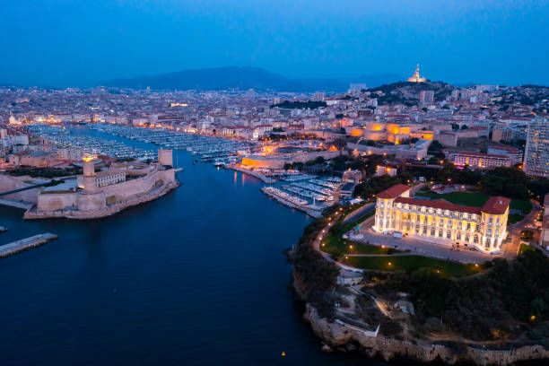 Bir's eye view of Marseille in evening Bir's eye view of Marseille in evening with turned on city lights. Palais du Pharo visible from above. old port photos stock pictures, royalty-free photos & images