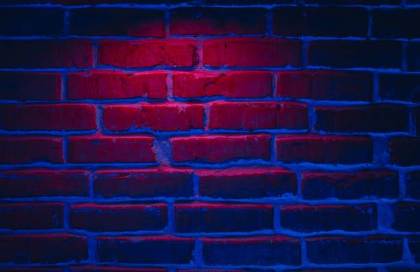 istock Brick wall texture background in red and blue neon lights 1347530496