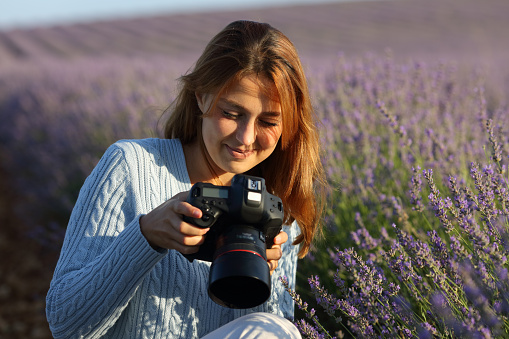 Photographer checking camera in lavender field