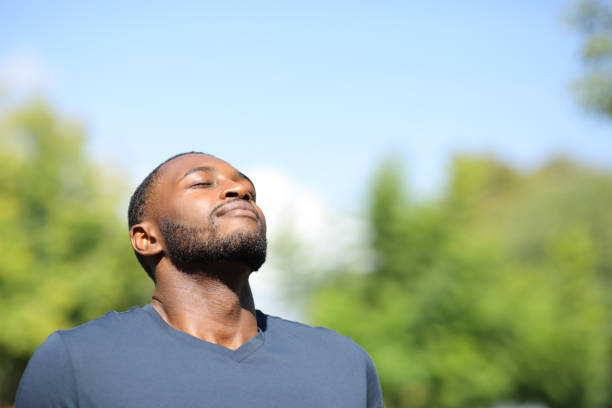Man with black skin breathing in nature Man with black skin breathing in nature breathing exercise stock pictures, royalty-free photos & images