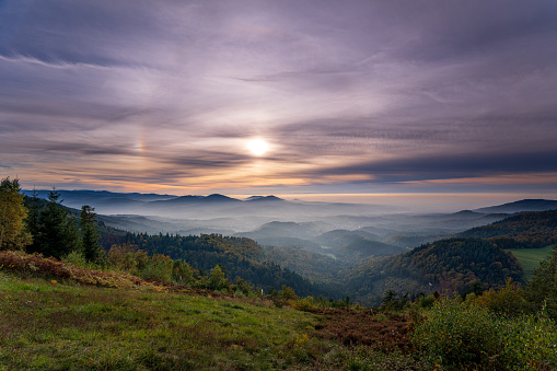Dreamlike autumn sunset with a 22° halo and two sun dogs over the Murgtal in the northern Black Forest