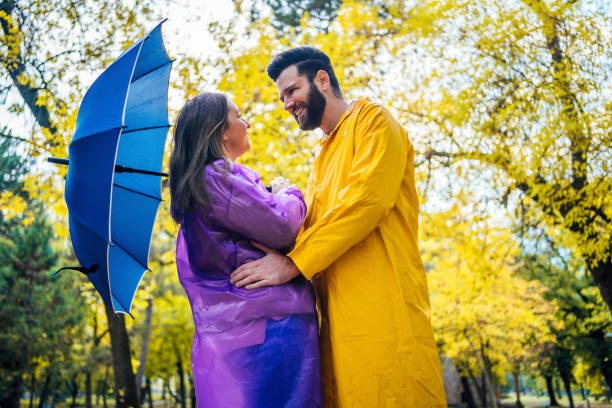 istock Love couple in raincoats 1347533894