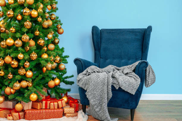 istock Holiday interior. Beautiful decorated christmas tree with blue armchair 1347534044