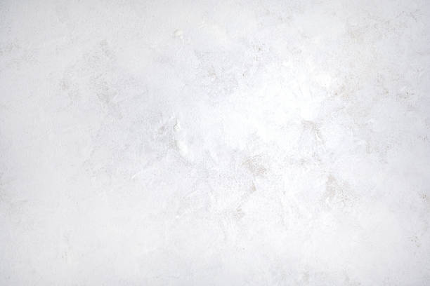 istock Rough white relief stucco wall close up. 1347539704