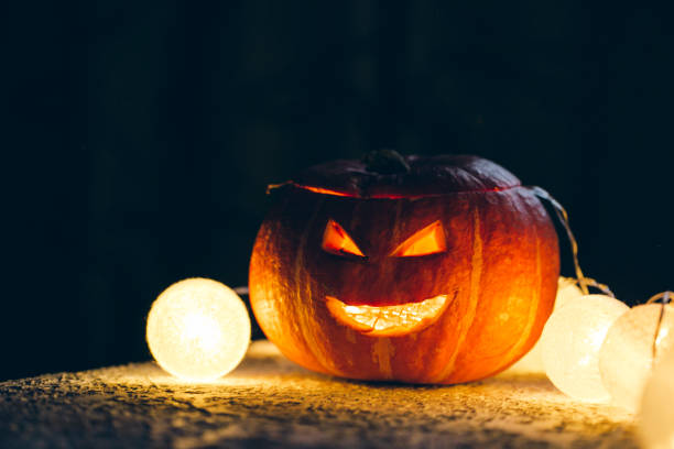 istock pumpkin with candles, halloween holiday concept 1347541135