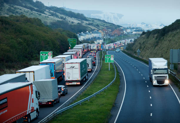 HGV trucks queue on the M20 motorway just outside Dover, the UK's largest Port. Dover, United Kingdom. 19th October 2021. HGV lorries queue on the M20 motorway just outside Dover, the UK's largest port and the main gateway to the European Union. brexit stock pictures, royalty-free photos & images