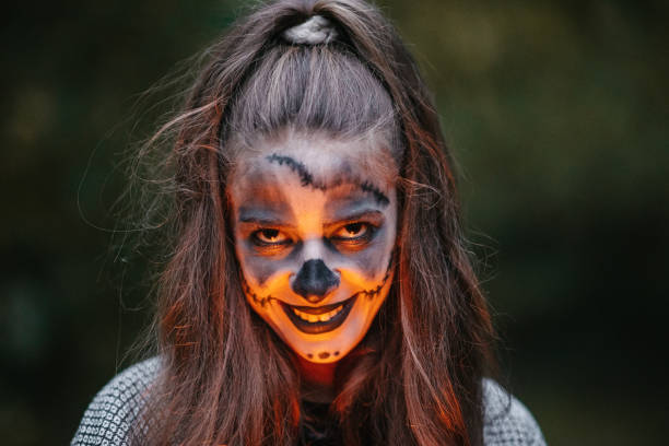 istock Young woman with a ponytail and stage make-up looking evil 1347543500