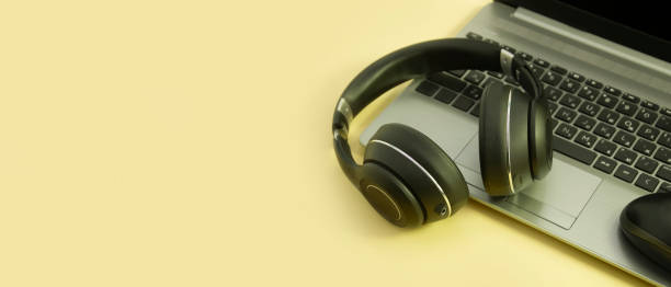 istock laptop, headphones on a colored background 1347543555
