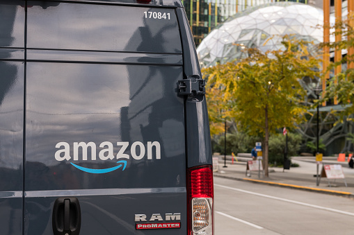 Seattle, USA - Oct 18, 2021: Late in the day an Amazon prime delivery truck by the Amazon HQ.