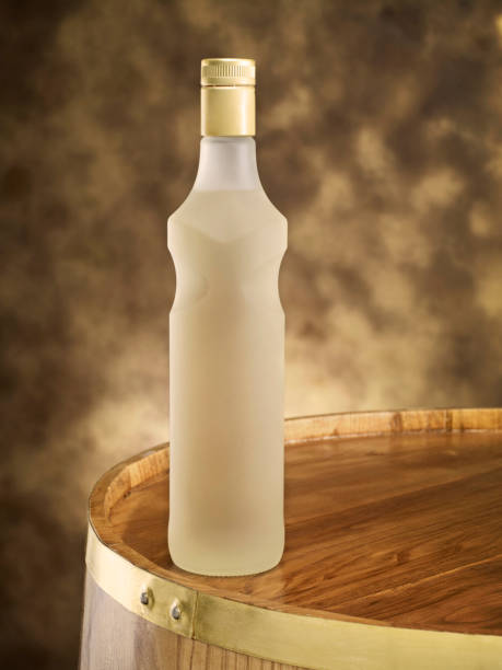flasche auf holzfass - distillery still stock-fotos und bilder
