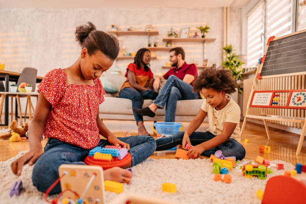 istock Two sisters playing together with building blocks 1347547747
