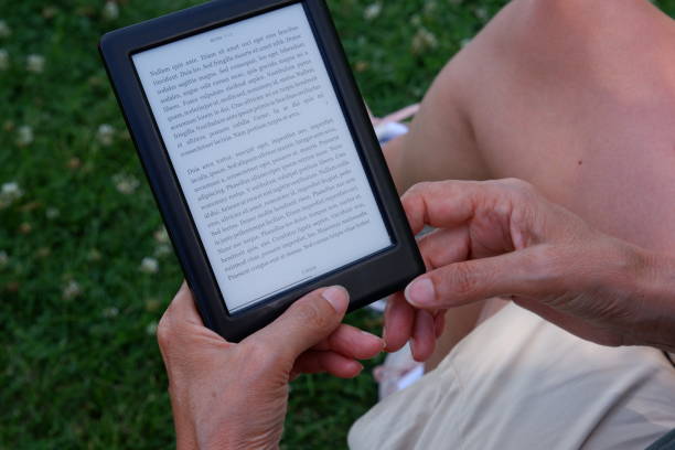 istock Old woman reading the e-book in the e-book reader. 1347548329