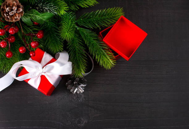 istock Black Christmas background with an empty space to copy. Christmas plate with a red winter flower 1347549261