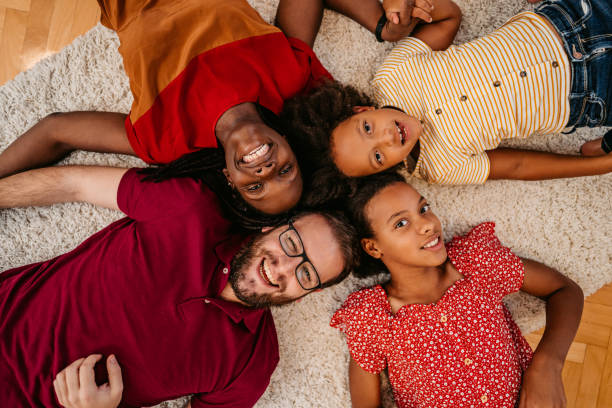 family circle on floor - couple loving lying on back carpet imagens e fotografias de stock