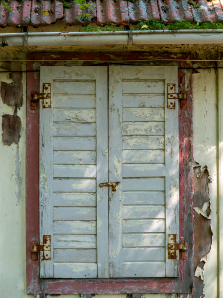 istock Old weathered and closed wooden shutter in an old abandoned ruin 1347551036