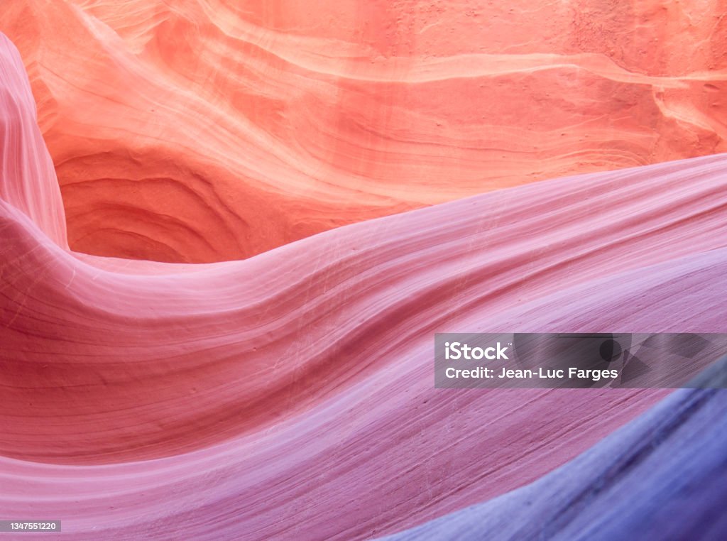 Purple, red, orange stone texture with copy space Purple, orange stone wave with copy space. Image taken in a slot canyon in Utah Nature Stock Photo