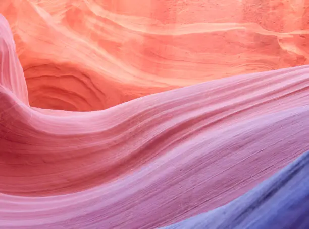 Purple, orange stone wave with copy space. Image taken in a slot canyon in Utah