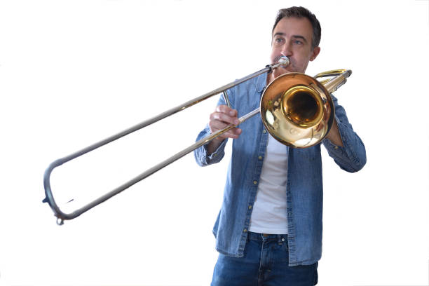 istock Trombonist playing trombone with white isolated background 1347556648