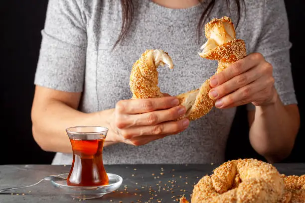 Photo of delicious Turkish bagel with sesame seeds known as susamli simit