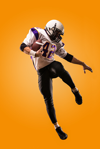 american football player in action. High jump of American football player.