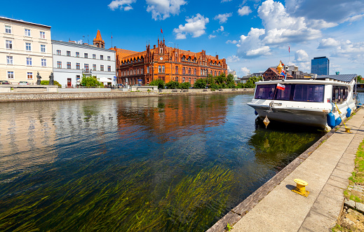 City embankment and river transport on a sunny day. Bydgoszcz. Poland.
