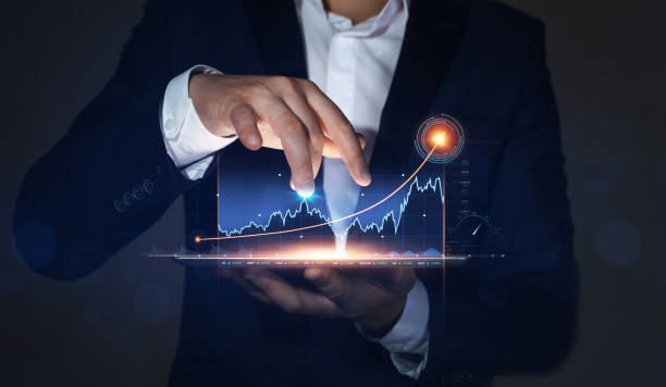 istock Businessman holding tablet with growing virtual hologram of statistics, graph and chart. Business strategy development and growing growth plan. 1347568261